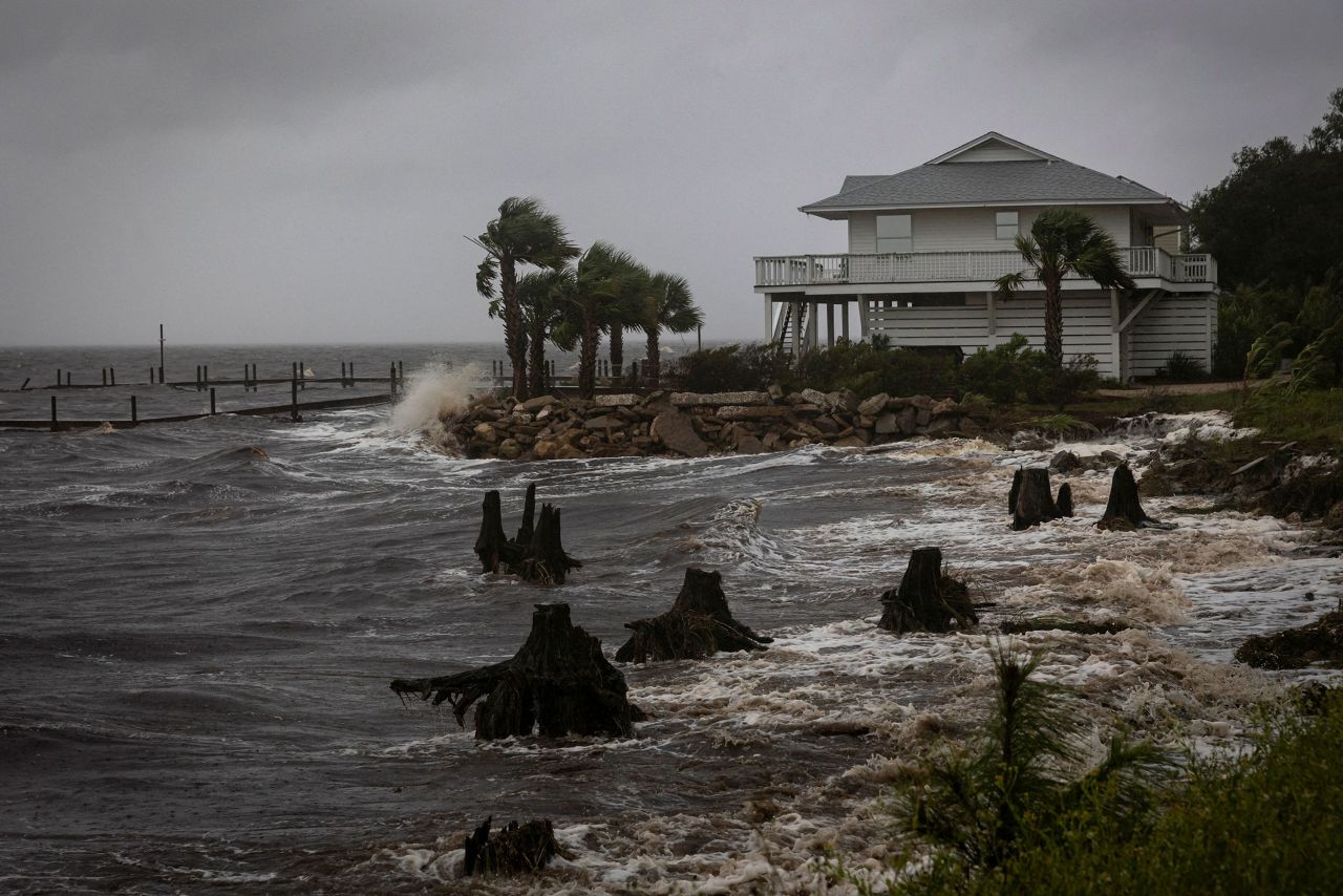 Waves impact a house seawall in Eastpoint, Florida, on Thursday.