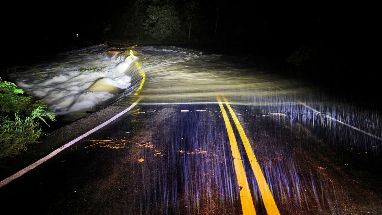 Flood waters wash over Guy Ford Road bridge on the Watauga River as Hurricane Helene approaches in the North Carolina mountains, in Sugar Grove, North Carolina, on September 26, 2024.