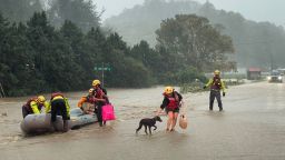 Residents lead their pets to safety as they are rescued by a swift water team amidst severe flooding as Tropical Storm Helene strikes, in Boone, North Carolina.