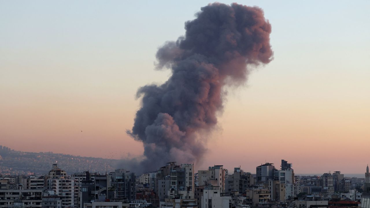 Smoke rises from behind a building in Beirut's southern suburbs following the strike.