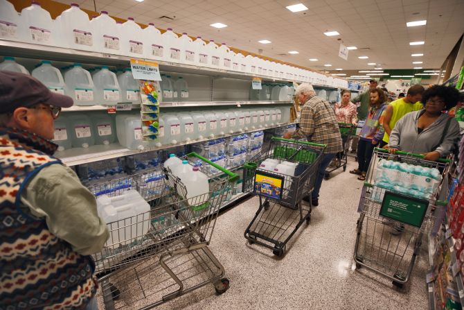 Customers crowd the aisle for bottled water in one of the few open stores after widespread damage disrupted water supplies in Boone, North Carolina, on Saturday.