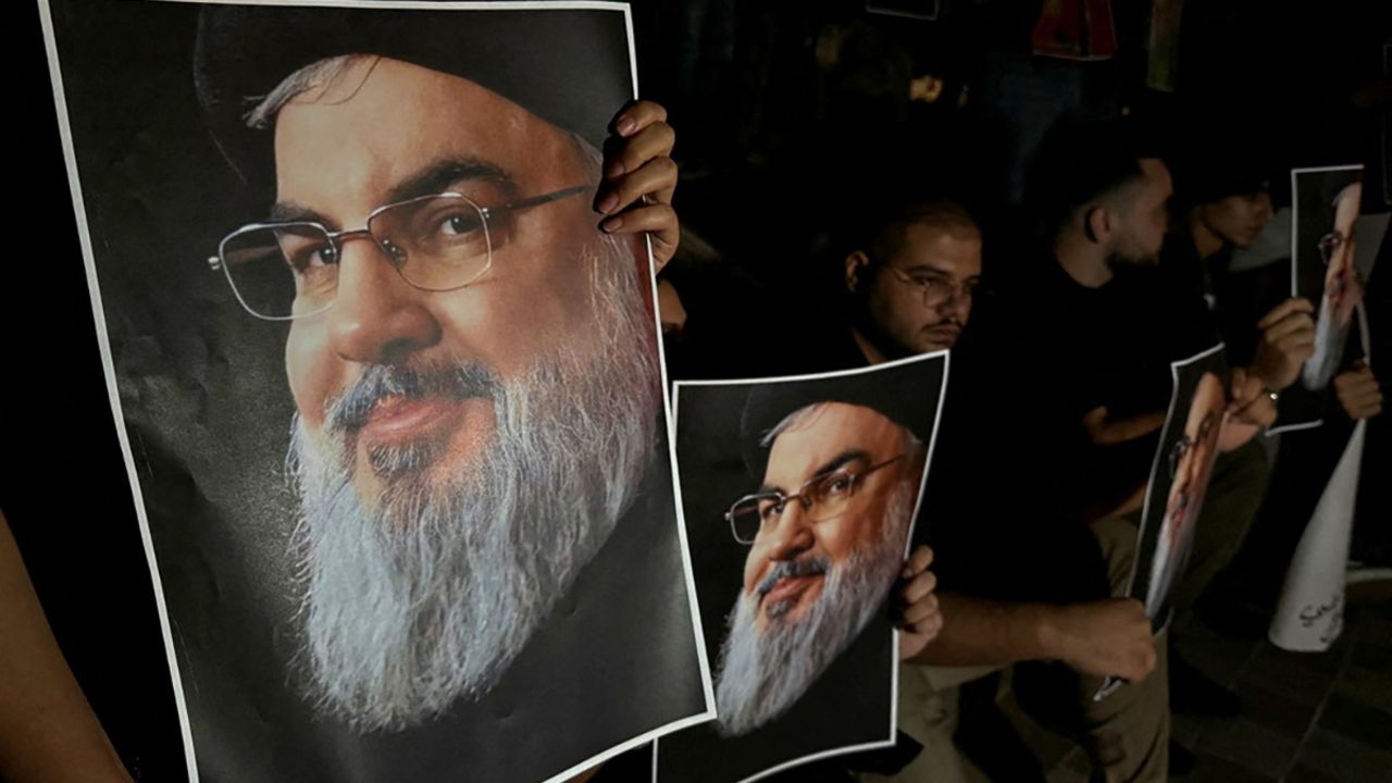 Supporters of Hezbollah leader Hassan Nasrallah carry his pictures as they gather in Sidon, Lebanon, following his killing in an Israeli airstrike in Beirut's southern suburbs on September 28, 2024.