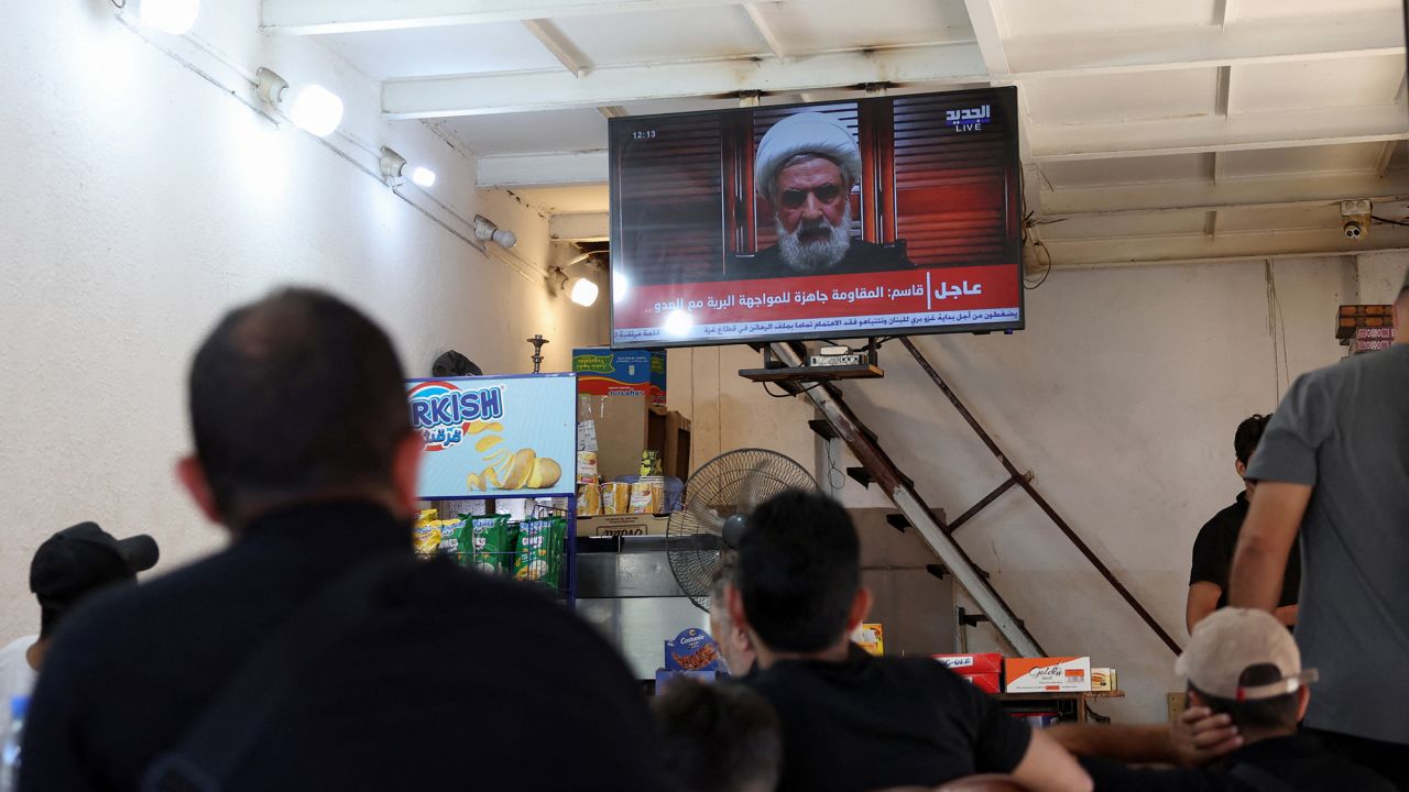 People watch Hezbollah deputy leader Sheikh Naim Qassem delivering a televised address, as they sit at a cafe in Beirut, Lebanon, on September 30.