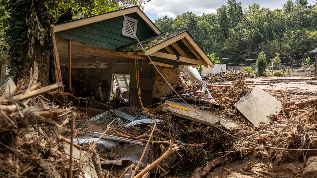 A destroyed house with a car under it is seen in Chimney Rock, North Carolina, on September 29.