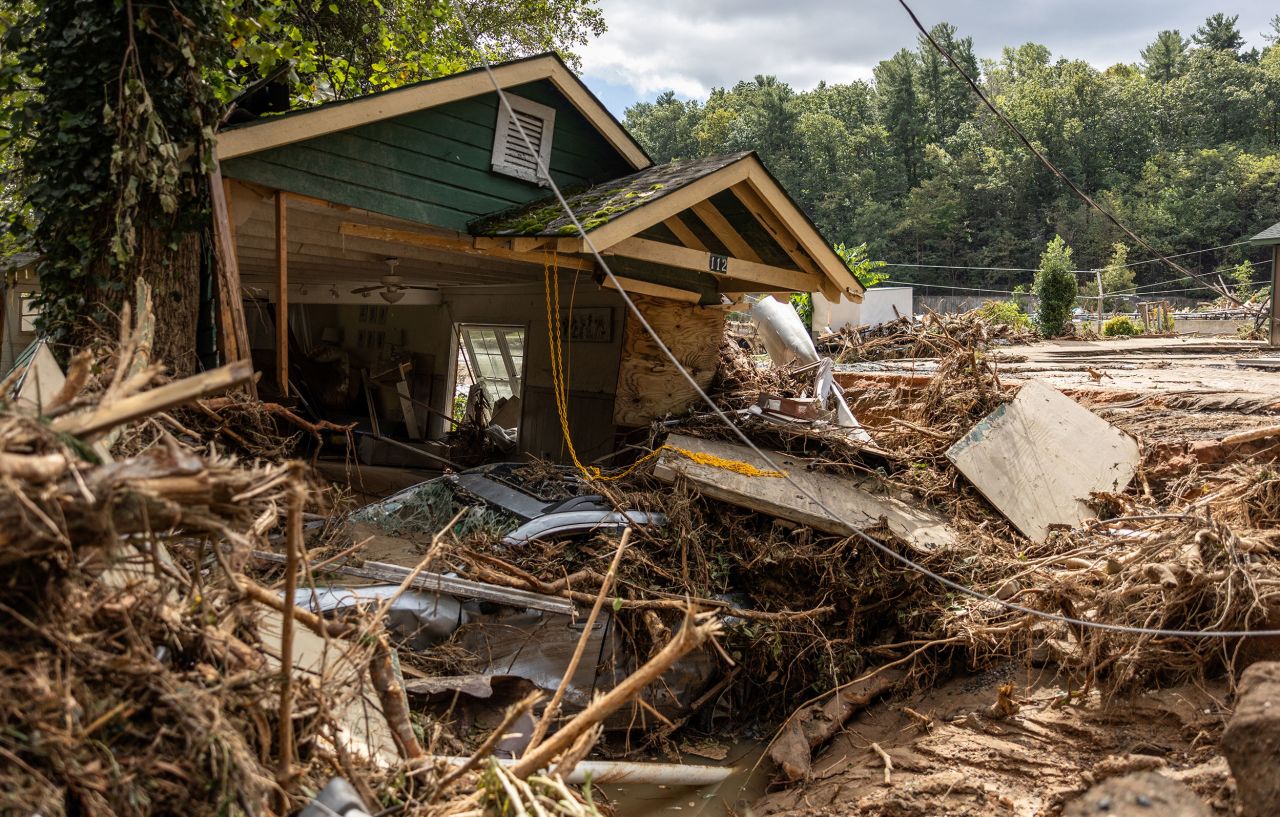 A destroyed house with a car under it is seen in Chimney Rock, North Carolina, on September 29.