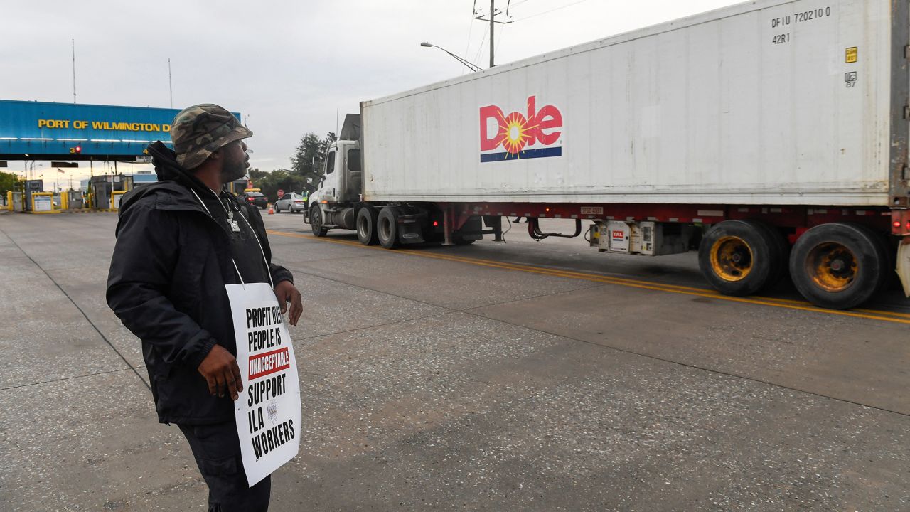 A dockworker demonstrates after a shipping port strike went into effect across the East Coast at the Port of Wilmington, Delaware, on October 1.