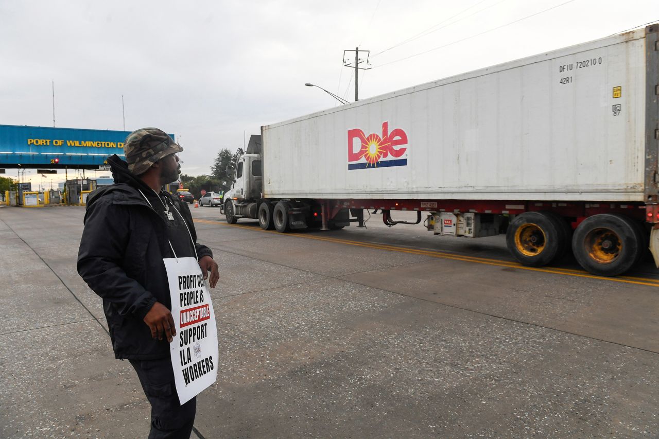 A dockworker demonstrates after a shipping port strike went into effect across the East Coast at the Port of Wilmington, Delaware, on October 1.