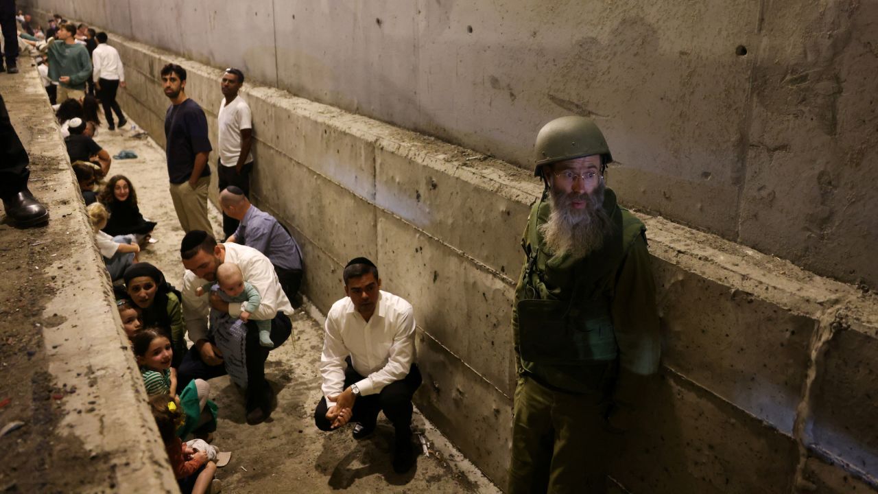 People take shelter during an air raid siren in central Israel.