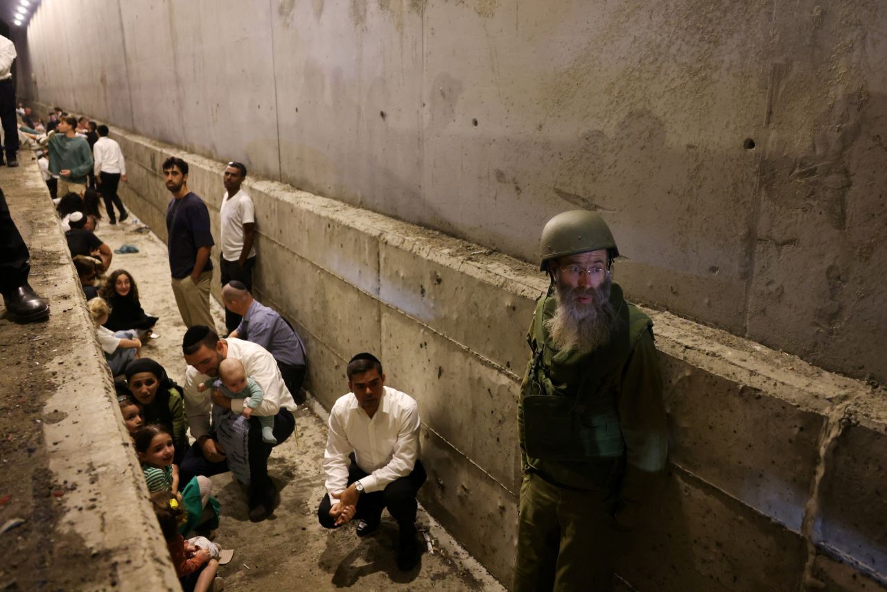 People take shelter during an air raid siren in central Israel.