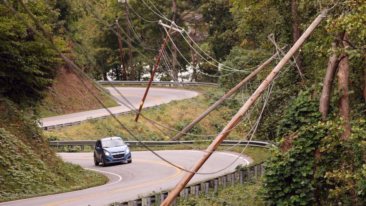 Power line poles lean after Hurricane Helene caused widespread damage to infrastructure in Lake Lure, North Carolina, on Tuesday.