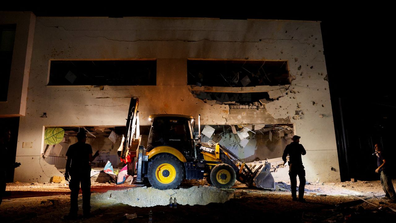 Israeli rescue force members inspect the site where a missile fired from Iran hit a school building in central Israel, on October 1, 2024.