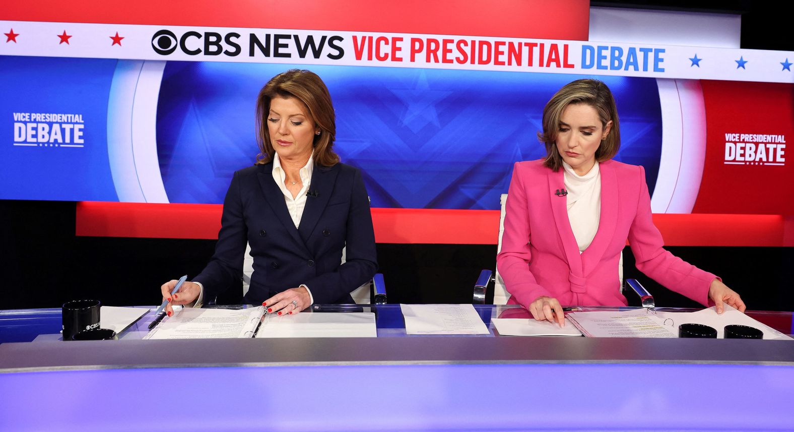 Debate moderations Norah O'Donnell, left, and Margaret Brennan review their notes during the debate.