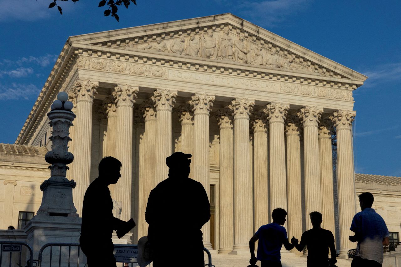 People are seen outside the Supreme Court building in Washington, DC, on June 29.