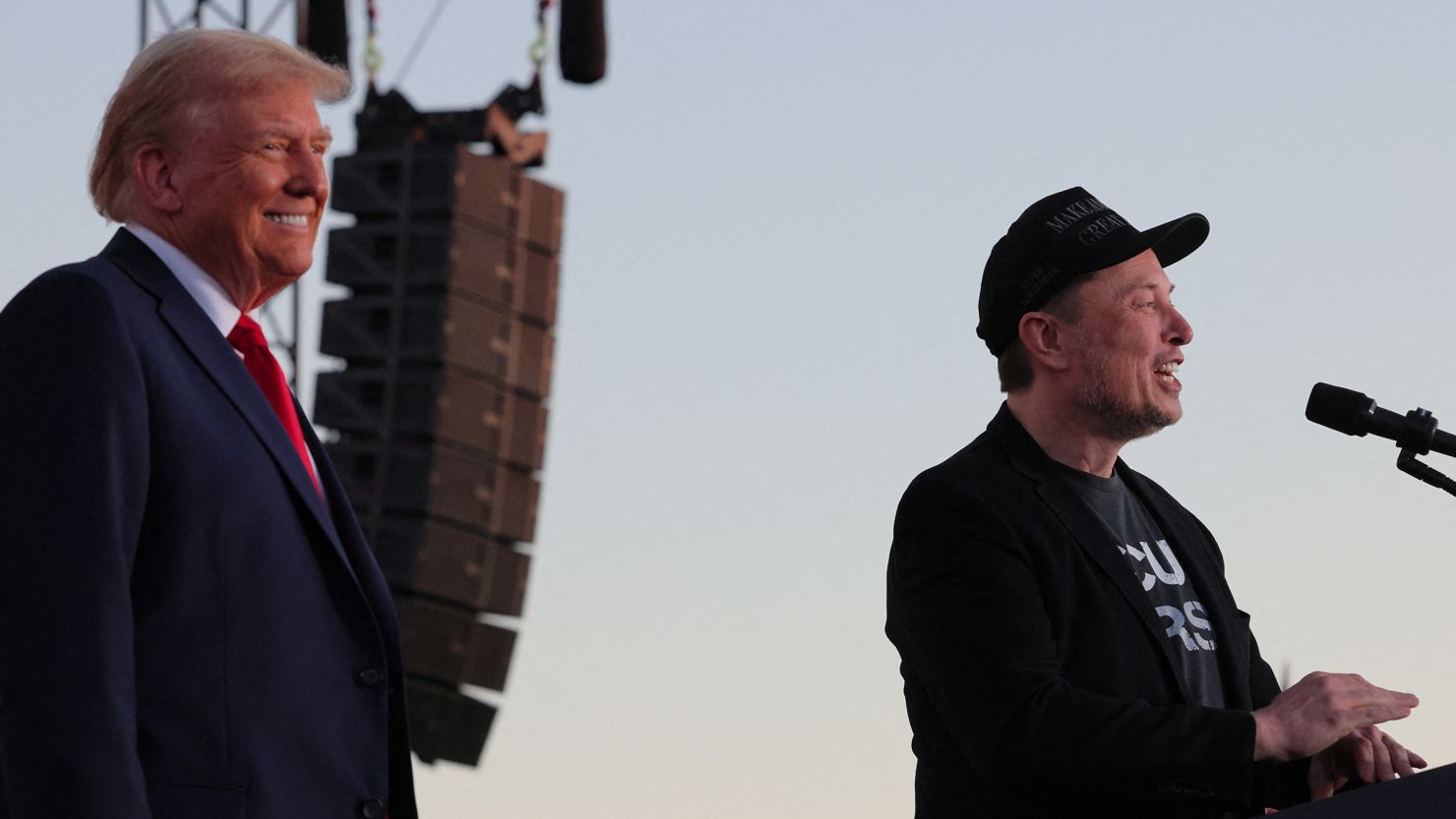 Tesla CEO Elon Musk speaks as former President Donald Trump looks on during a campaign rally in Butler, Pennsylvania, on October 5, 2024.