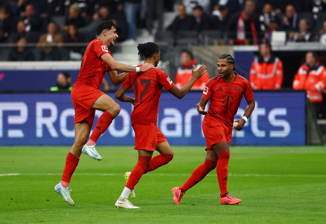 Olise celebrates with his teammates after giving Bayern the lead.