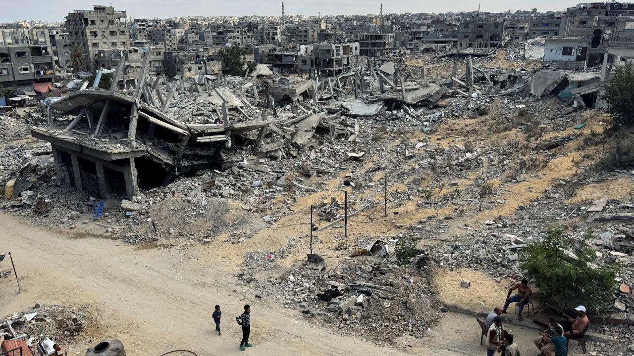 Palestinians walk past the rubble of houses destroyed in Israel's military offensive in Khan Younis, Gaza, on October 7.