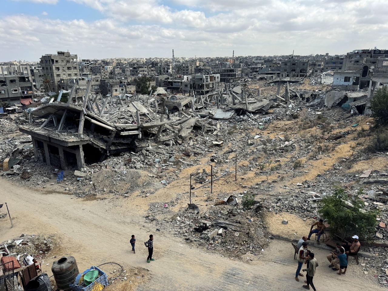 Palestinians walk past the rubble of houses destroyed in Israel's military offensive in Khan Younis, Gaza, on October 7.