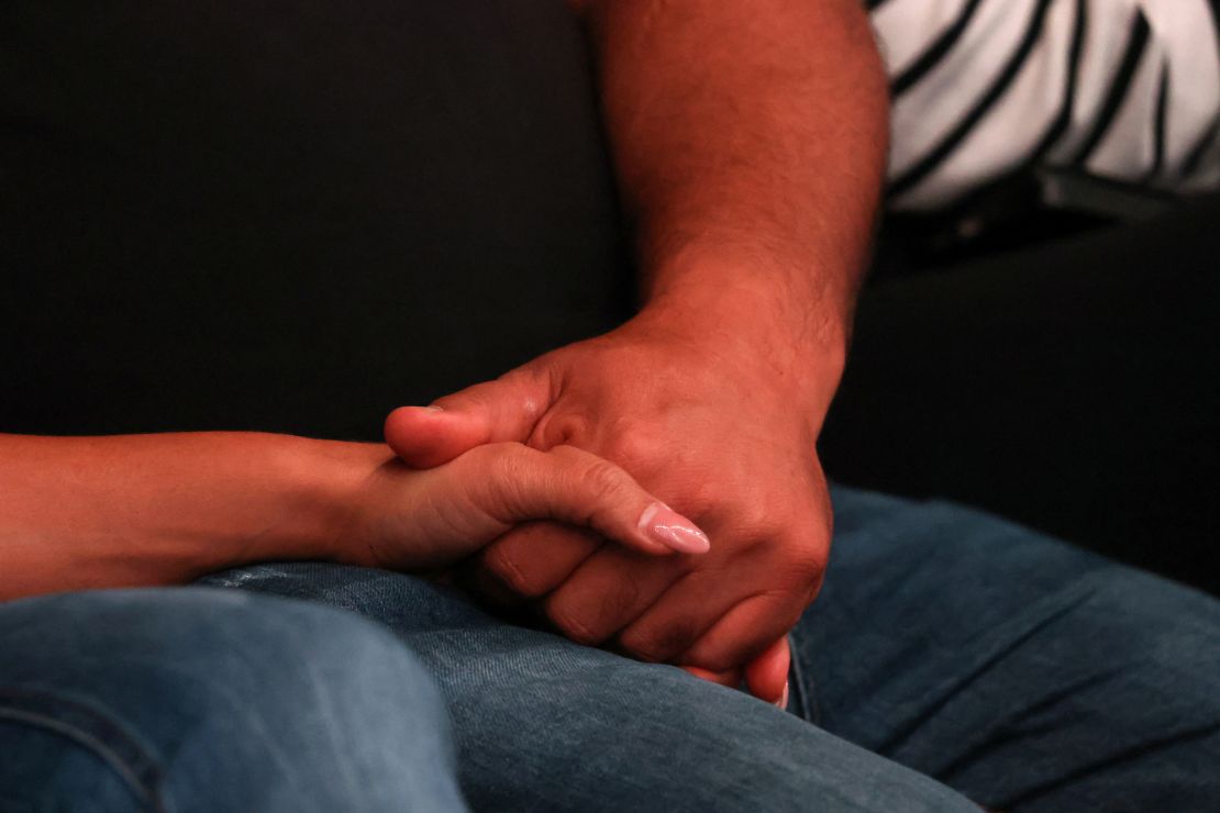 People hold hands as they attend a memorial ceremony organized by the families of hostages held in Gaza to mark one year after the deadly Oct. 7 Hamas attack at a park in Tel Aviv, Israel, Oct. 7, 2024 to celebrate.