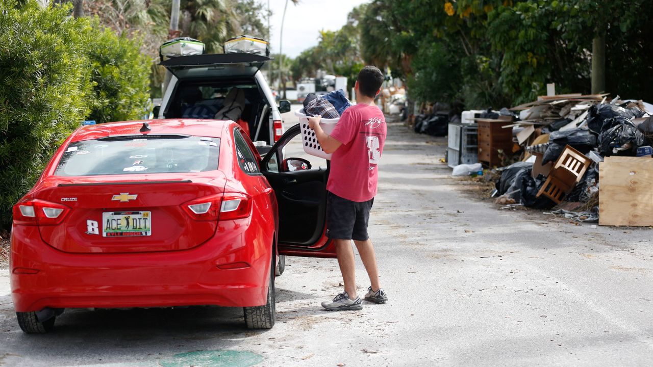 Sam Grande carries his belongings as he prepares to evacuate his home before the arrival of Hurricane Milton, in St. Pete Beach, Florida, on Monday.