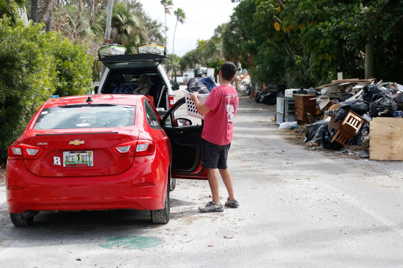 Sam Grande carries his belongings as he prepares to evacuate his home before the arrival of Hurricane Milton, in St. Pete Beach, Florida, on Monday.