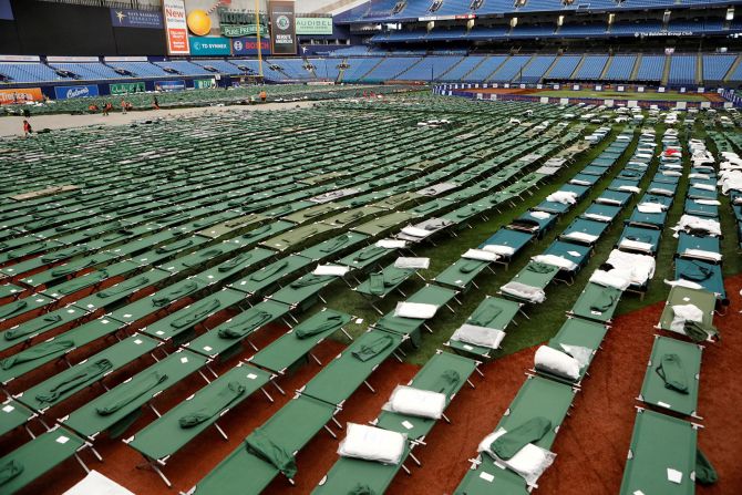 Tropicana Field opened Monday as a staging site for workers and operations. Part of its roof was later torn off during the storm.