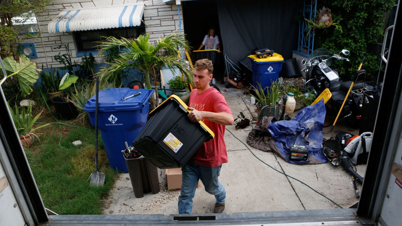 Cobi Pepperman helps his father load belongings in a truck while preparing to evacuate from their home ahead of Hurricane Milton in New Port Richey, Florida, on Tuesday.