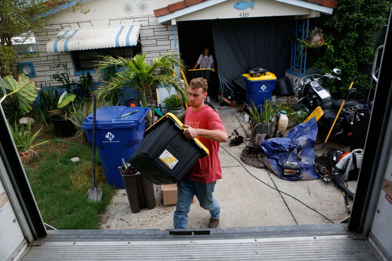 Cobi Pepperman helps his father load belongings in a truck while preparing to evacuate from their home ahead of Hurricane Milton in New Port Richey, Florida, on Tuesday.