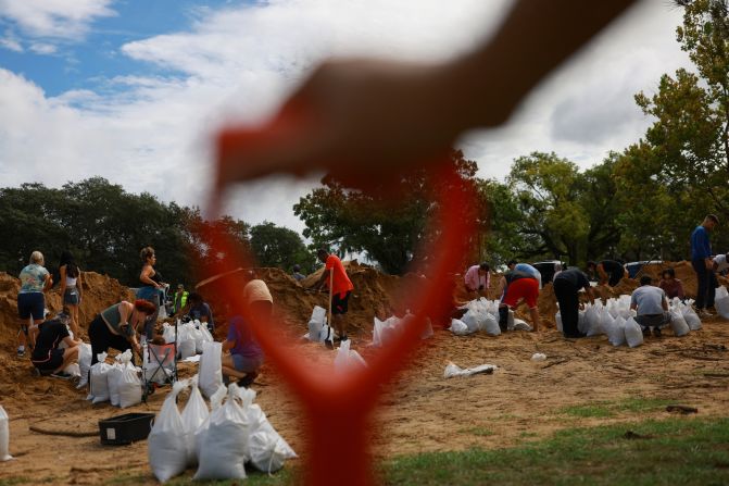 People prepare sandbags in Orlando on Tuesday.