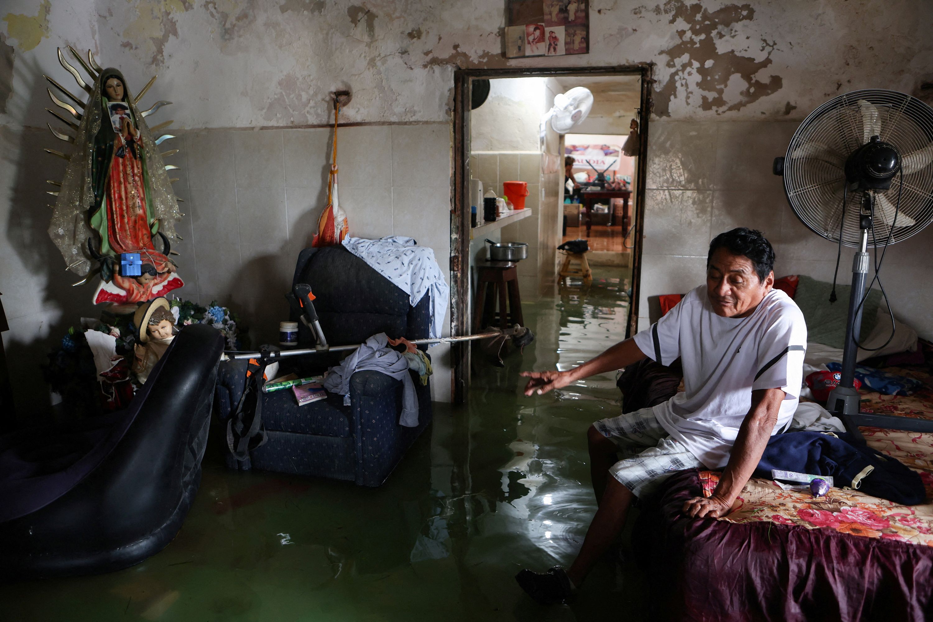 Aurelio Ortiz sits in his flooded home in Celestún, Mexico, on Tuesday.