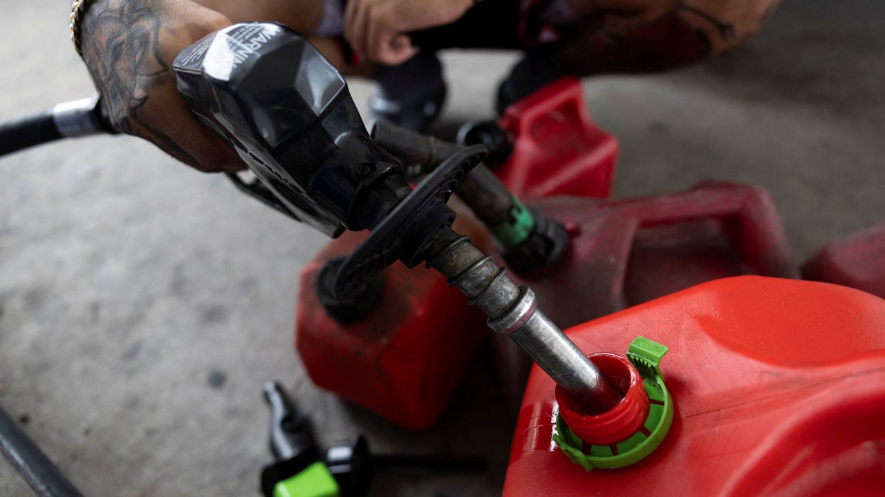 A man fills up gas containers in Tampa, Florida, on October 8.