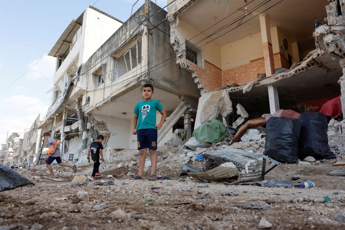 Palestinian children play near destroyed houses in Nur Shams refugee camp near Tulkarm, in the Israeli-occupied West Bank, September 19, 2024. REUTERS/Mohammed Torokman