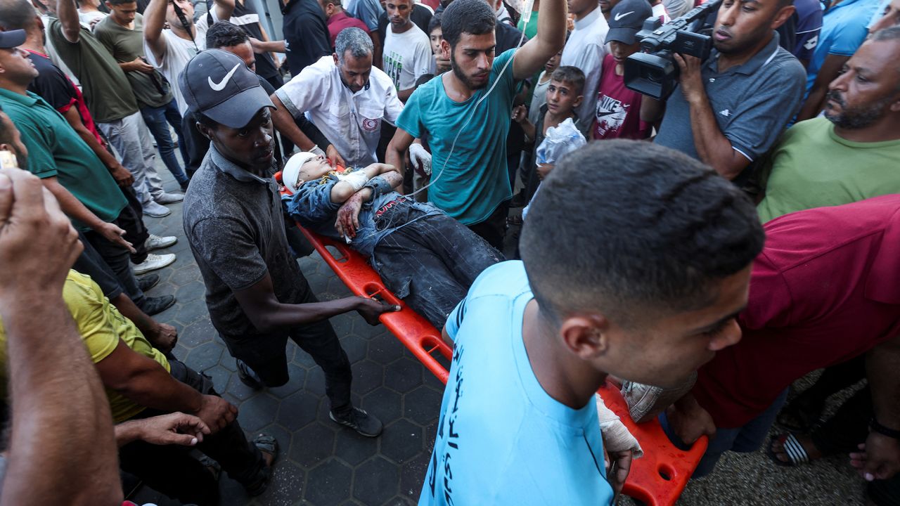 A wounded Palestinian is carried to Al-Aqsa Martyrs Hospital in Deir Al-Balah, Gaza, on October 10.