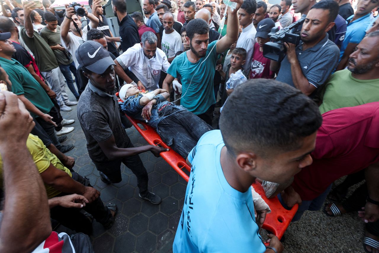 A wounded Palestinian is carried to Al-Aqsa Martyrs Hospital in Deir Al-Balah, Gaza, on October 10.