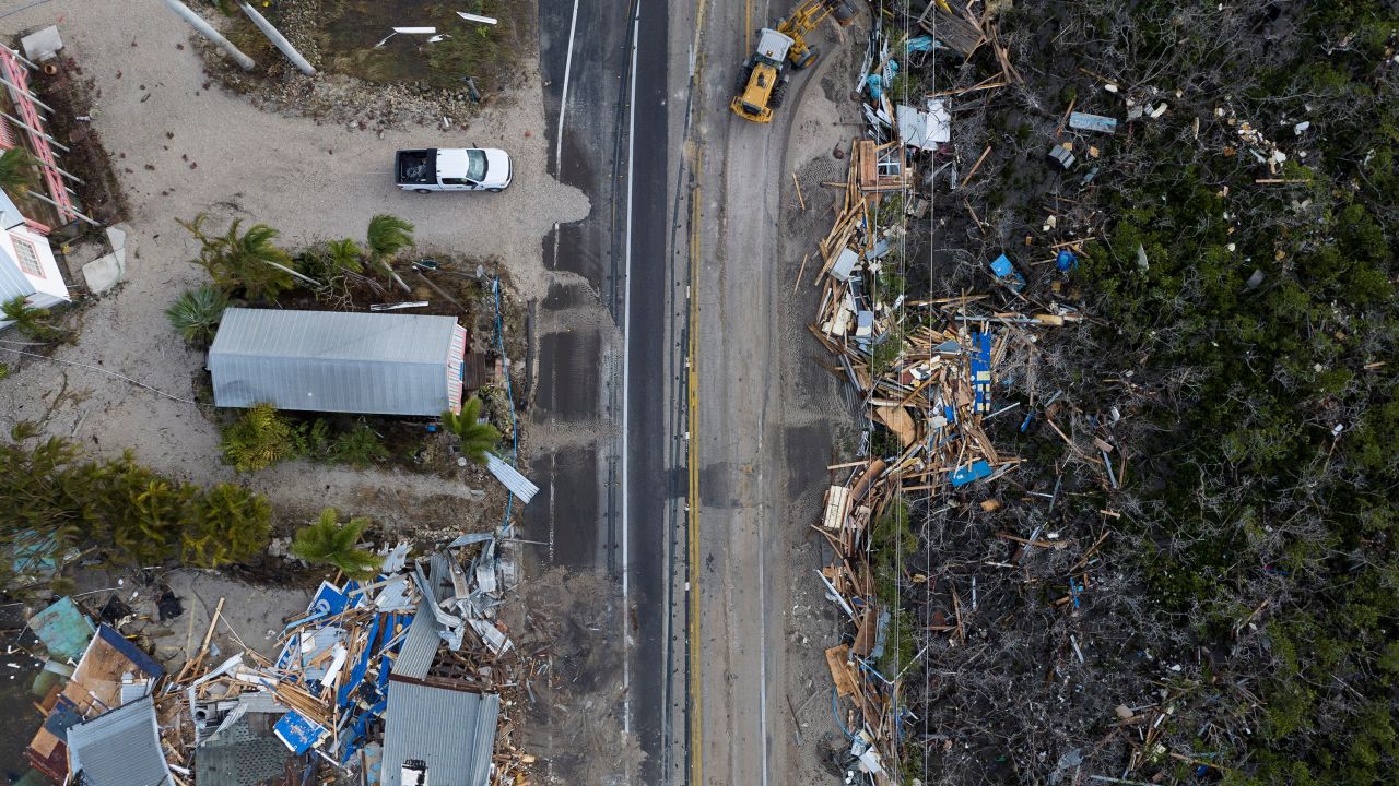 A drone view shows a bulldozer removing debris from a road after Hurricane Milton made landfall in Matlacha, Florida, on October 10.