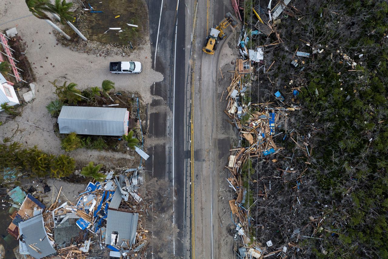 A drone view shows a bulldozer removing debris from a road after Hurricane Milton made landfall in Matlacha, Florida, on October 10.