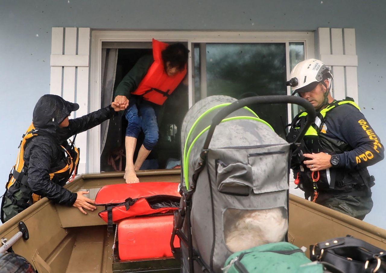 Volusia Sheriff's Special Ops team members rescue residents in South Daytona, Florida, on Thursday.