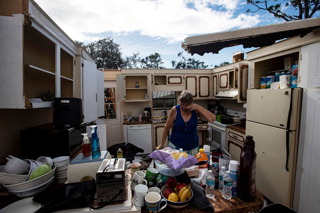 Liz Kelly salvages items from her destroyed home in North Fort Myers, Florida, on Thursday. A tornado associated with Hurricane Milton ripped through their neighborhood.