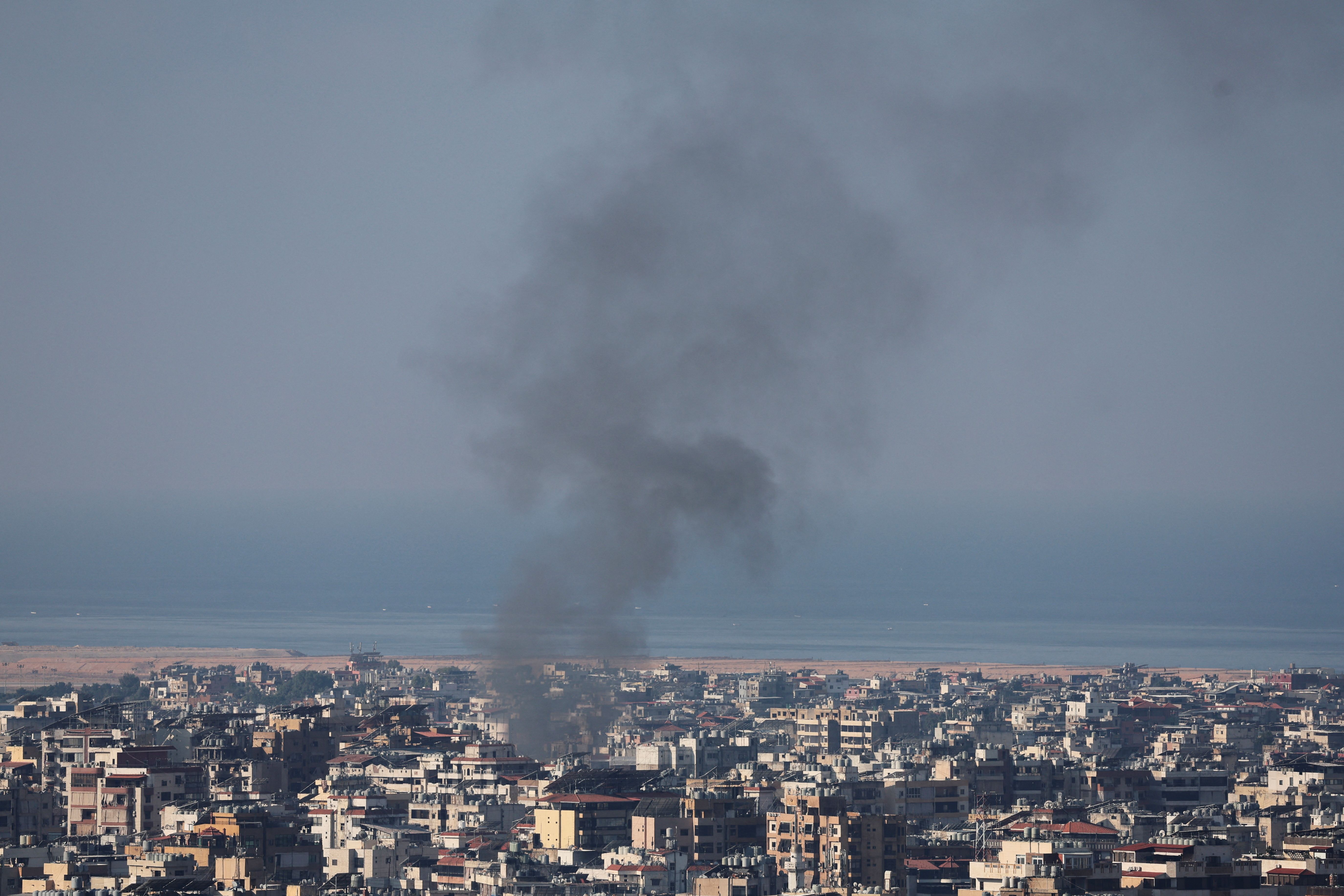 smoke rises over beirut's southern suburbs after israeli air strikes, amid ongoing hostilities between hezbollah and israeli forces.