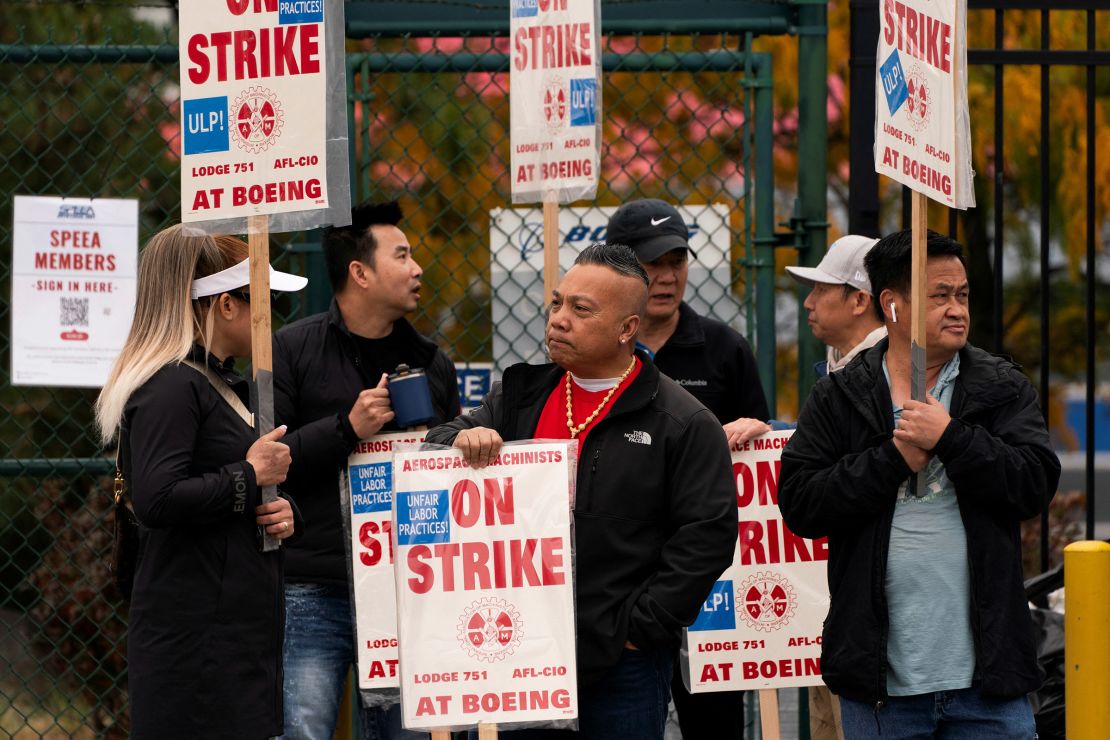 Boeing factory workers and supporters gather on a picket line near the entrance to a Boeing production facility in Renton, Washington.