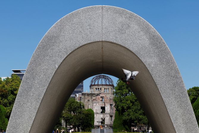 The Cenotaph for the Victims of the Atomic Bomb and the preserved Atomic Bomb Dome at the Hiroshima Peace Memorial Park in Japan.