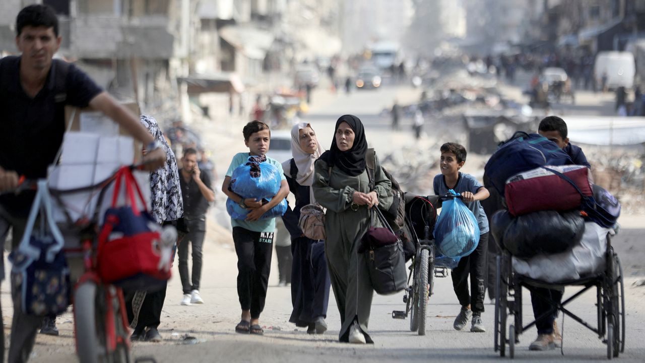 Displaced Palestinians make their way as they flee areas in northern Gaza following an Israeli evacuation order on October 12.