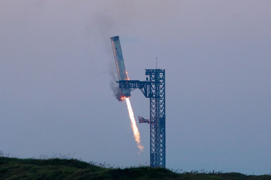 SpaceX's Super Heavy booster is captured by two massive metal pincers, or 