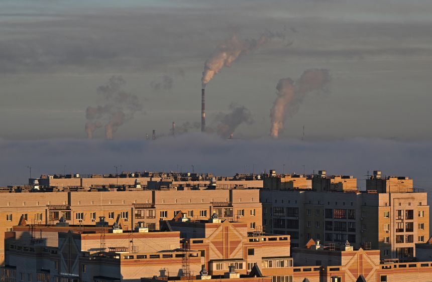 Steam rises from the chimneys of a thermal power plant and an oil refinery in Omsk, Russia, in October 2024.