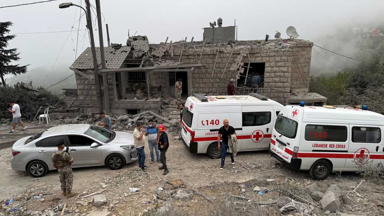 Lebanese Red Cross vehicles are parked at a site damaged by an Israeli air strike in the Christian-majority region of Aitou in north Lebanon on October 14.