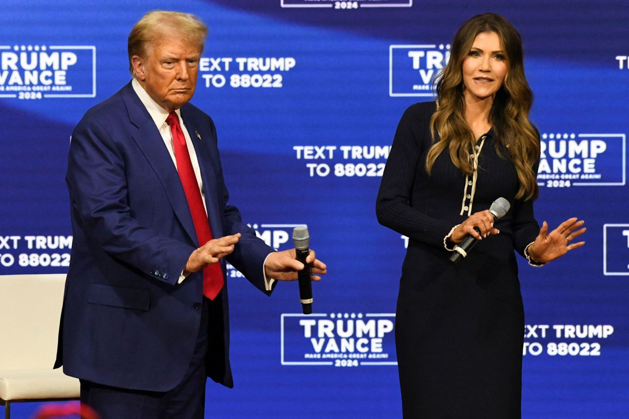 Former President Donald Trump and South Dakota Gov. Kristi Noem dance during a town hall campaign event in Oaks, Pennsylvania, on Monday.