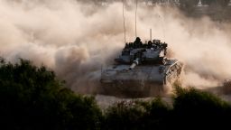 An Israeli tank maneuvers near the Israel-Gaza border, as seen from Israel, on October 15.