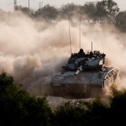 An Israeli tank maneuvers near the Israel-Gaza border, as seen from Israel, on October 15.