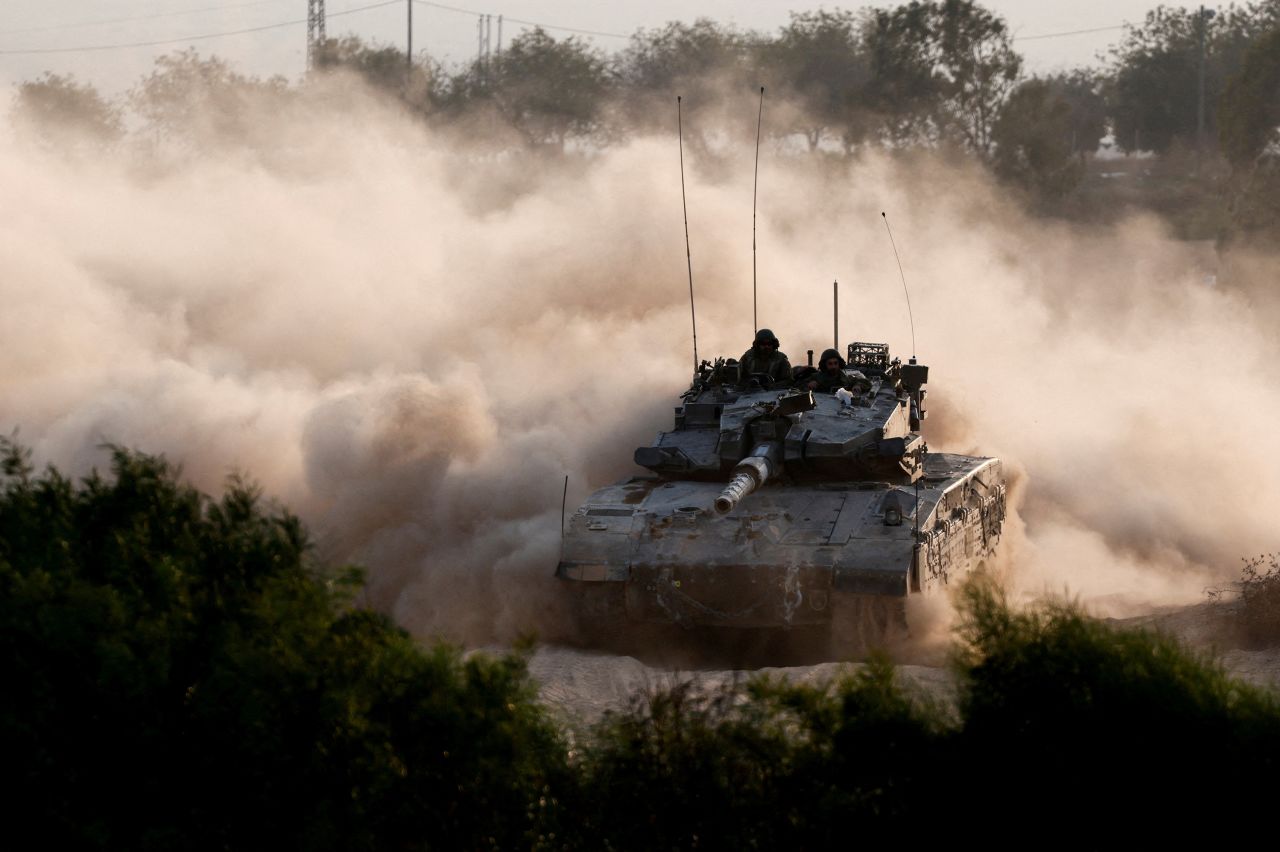 An Israeli tank maneuvers near the Israel-Gaza border, as seen from Israel, on October 15.