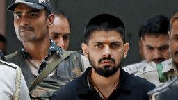 Policemen escort Lawrence Bishnoi at a court, in New Delhi, India on April 18, 2023.