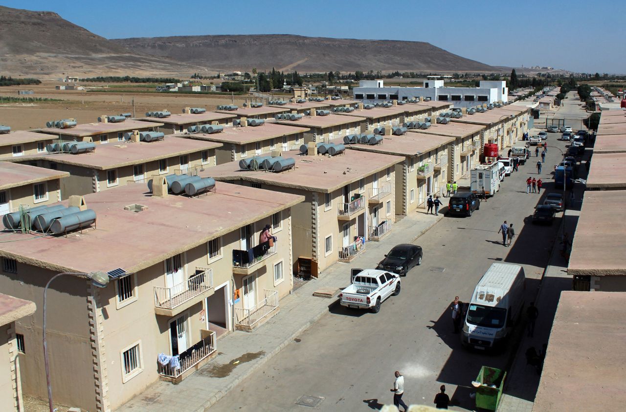 People walk at a shelter housing displaced people who fled from Lebanon to Syria in Herjelleh, Syria, on October 15.